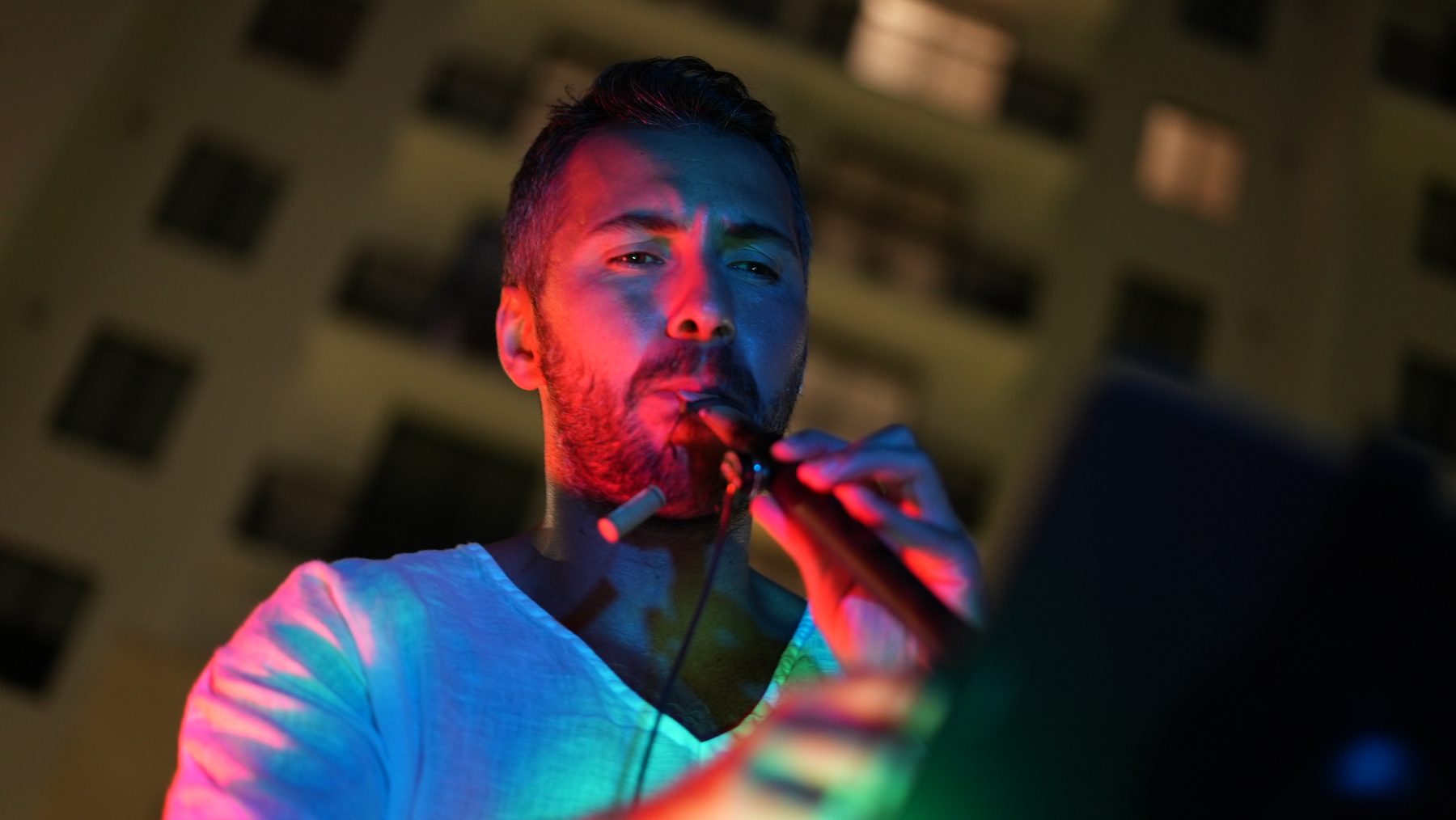 Alp Akmaz performing in dramatic light