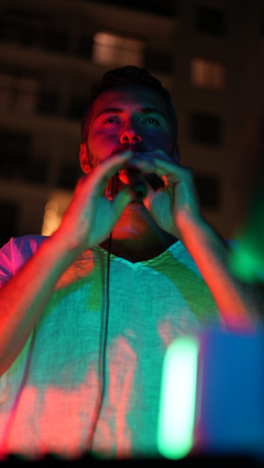 Alp Akmaz under colored lights